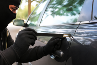 Slim Jim Tool near a locked car door with focus on lockout risks and safer alternatives
